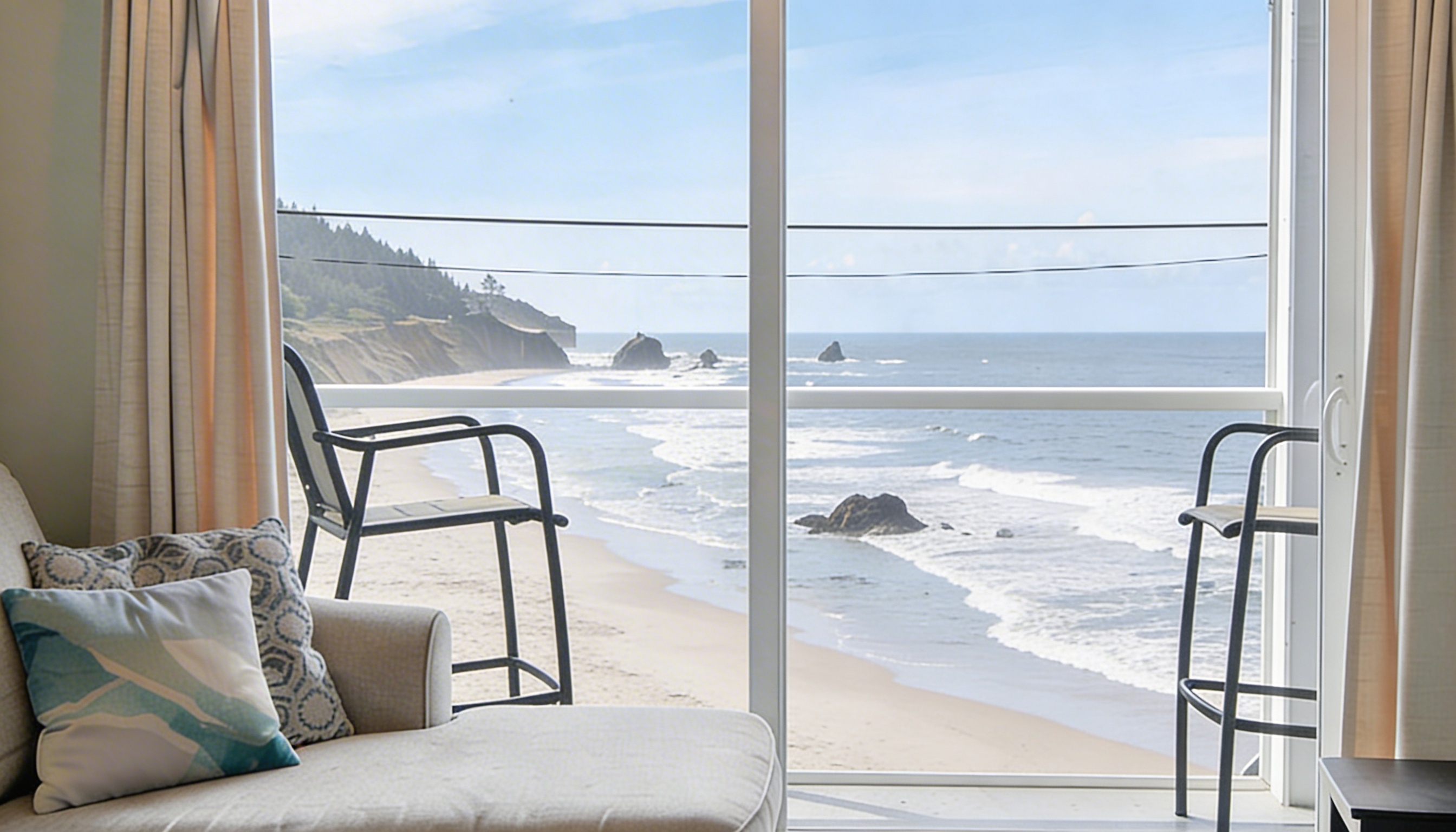 Living room with panoramic ocean view at Three Arch Inn